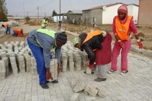 People pictured working with bricks