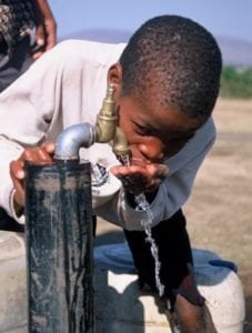 kid drinkiing from tap image