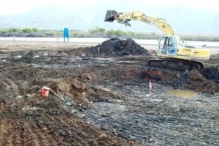 An excavator removes hazardous waste.