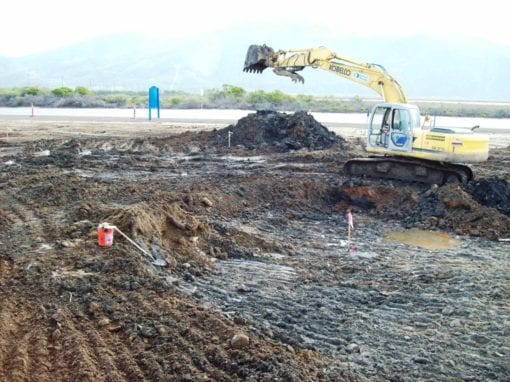 An excavator removes hazardous waste.