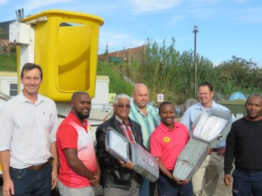 Portfolio Councillor for Electro-technical Services, Edmund Bussack holds the new compact energy efficient LED light fitting. From the left – Steyn Van Der Merwe, Deputy Director Planning and Design Electro-Technical Services, George Municipality, Masithenbe Bam Izazi Technologies, Cllr Bussack, Deon Esterhuysen, Senior Manager Planning Electro-Technical Services, George Municipality, Osmond Ngcizela Izazi Technologies (holding an example of the old bulky streetlight fitting), Stephen Meggersee, Associate for Clinckscales Maughan-Brown and Luncedo Gadu, Izazi Technologies.