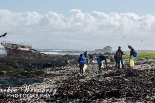 A beach cleanup in progress at Robben Island as part of the 2018 International Coastal Clean-Up Day