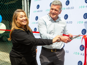 Marius Erasmus and Kerry-Leigh Kemp cutting the ribbon at the opening of the recycling plant.