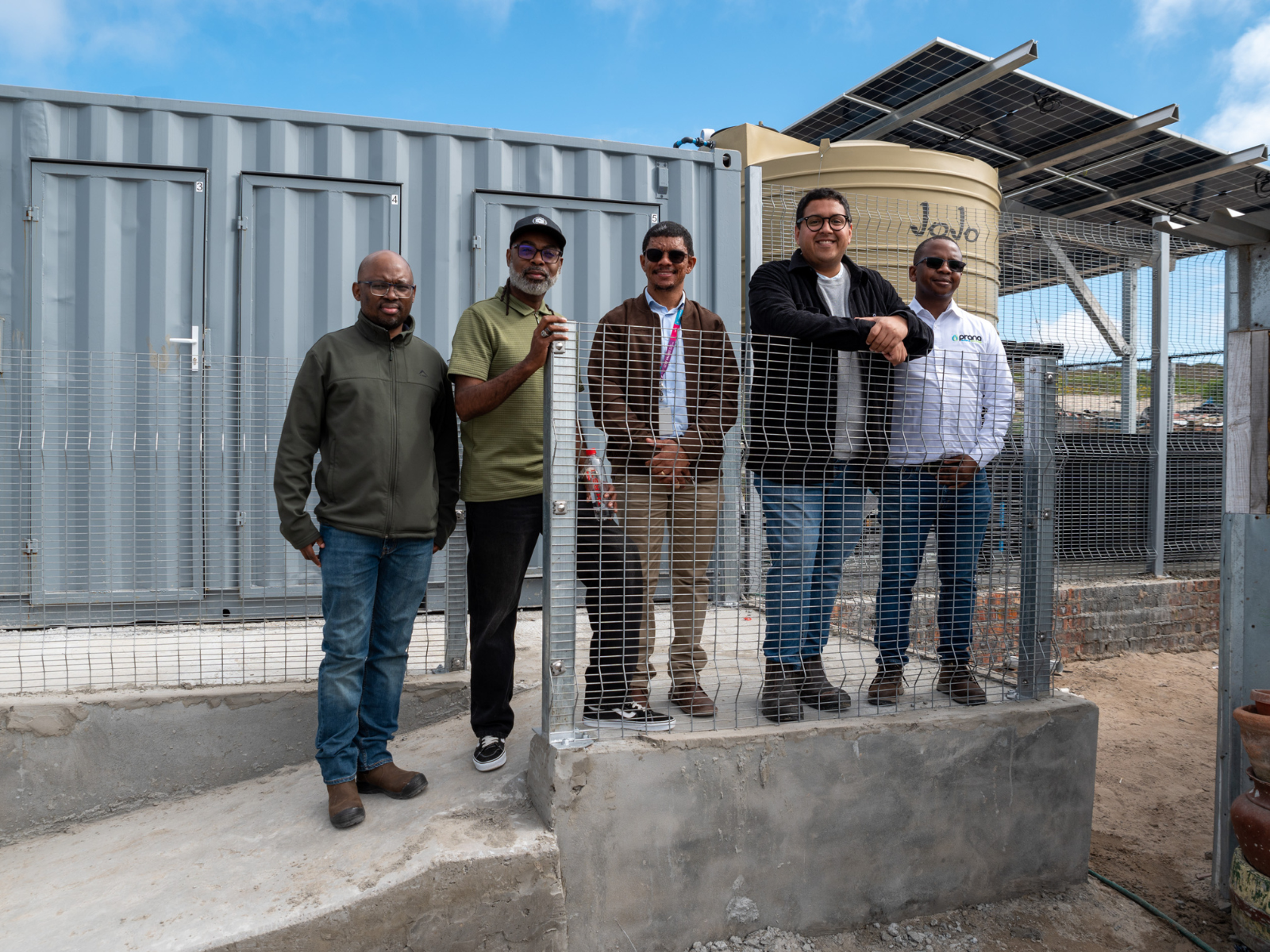 Councillors Badroodien and Jansen with Sandile Gqoboka (Head: Project Management Unit, Water and Sanitation Department) (left), Denvor Cloete (Project Manager, Water and Sanitation Department) (middle) and Letsatsi Lesufi (Prana ATS) (right) in front of the new toilet cubicles.