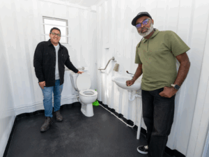 Councillors Zahid Badroodien and Elton-Enrique Jansen view the specially designed cubicle for wheelchair users, which provides additional space and accessibility features.