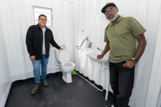 Councillors Zahid Badroodien and Elton-Enrique Jansen view the specially designed cubicle for wheelchair users, which provides additional space and accessibility features.