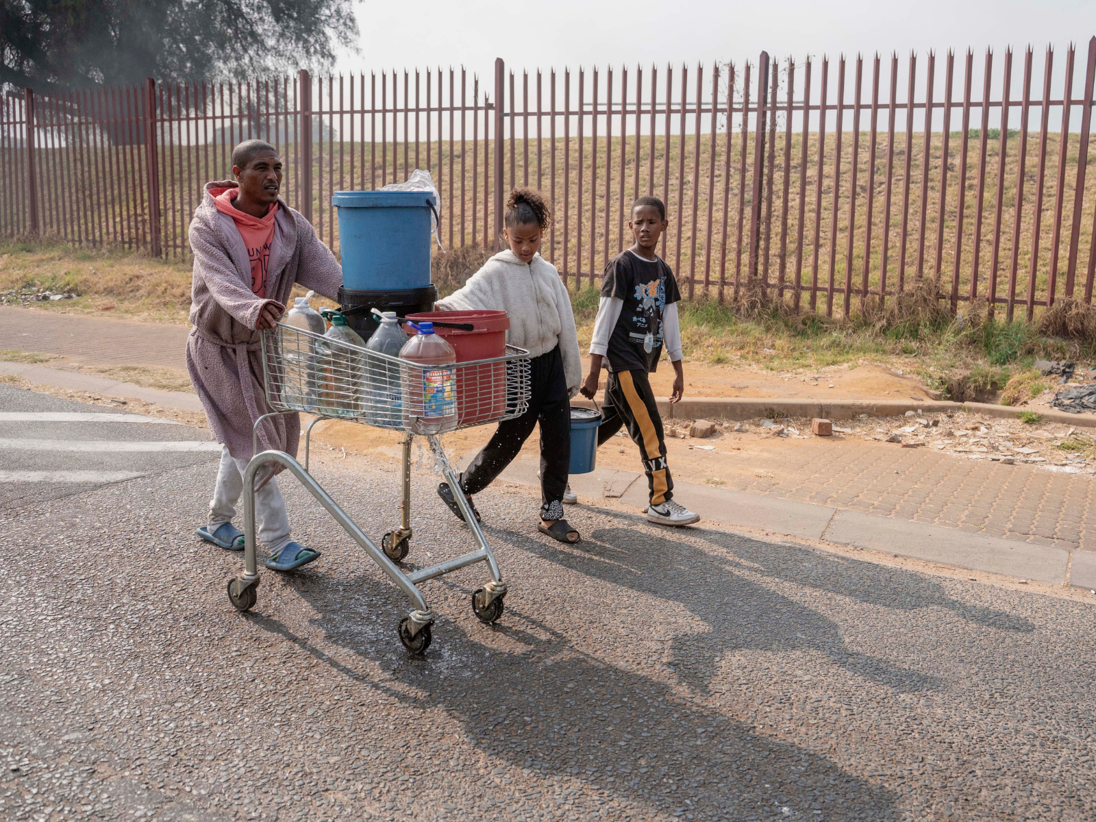 Jason Pieters pushing a trolley with bottles of water for his family