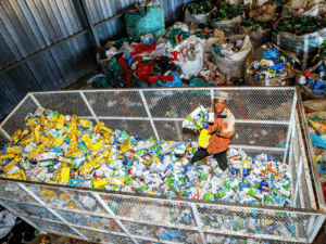 Koos Rapulane of Boikanyo Lesedi Environmental Waste Management surveys a mountain of liquid board cartons collected for recycling