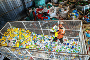 Koos Rapulane of Boikanyo Lesedi Environmental Waste Management surveys a mountain of liquid board cartons collected for recycling