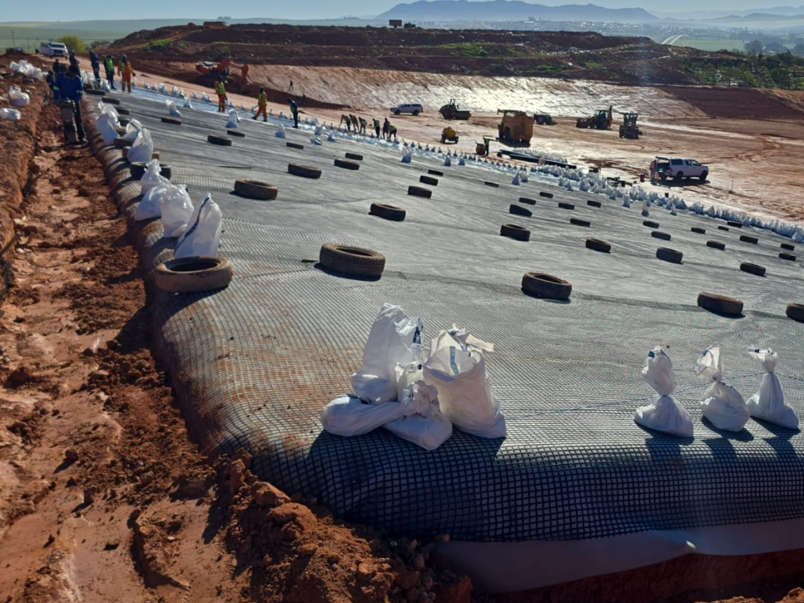 Installation of geosynthetic materials as part of an engineered landfill liner
