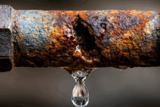 water leak from a corroded water pipe due to rust