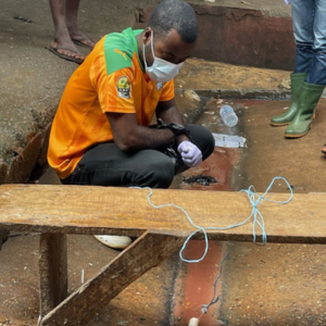 Cote d’Ivoirelaboratory staff set up a passive sample of water runoff from cleaning poultry at an urban market