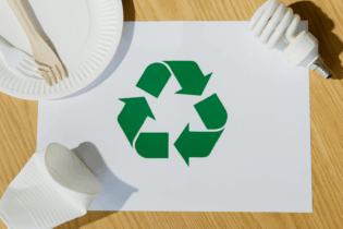 Recycling symbol surrounded by waste