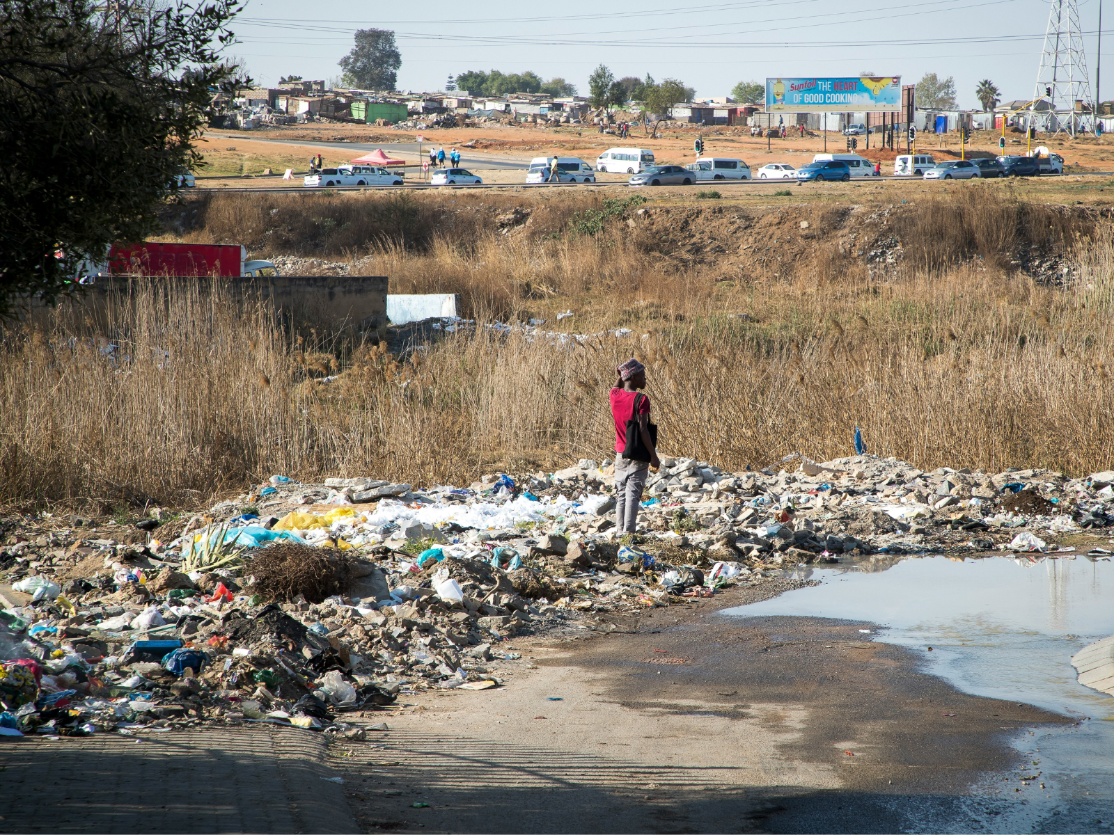 south african township in rubbish and waste near river