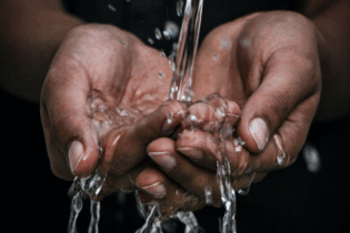 collecting water in cupped hands