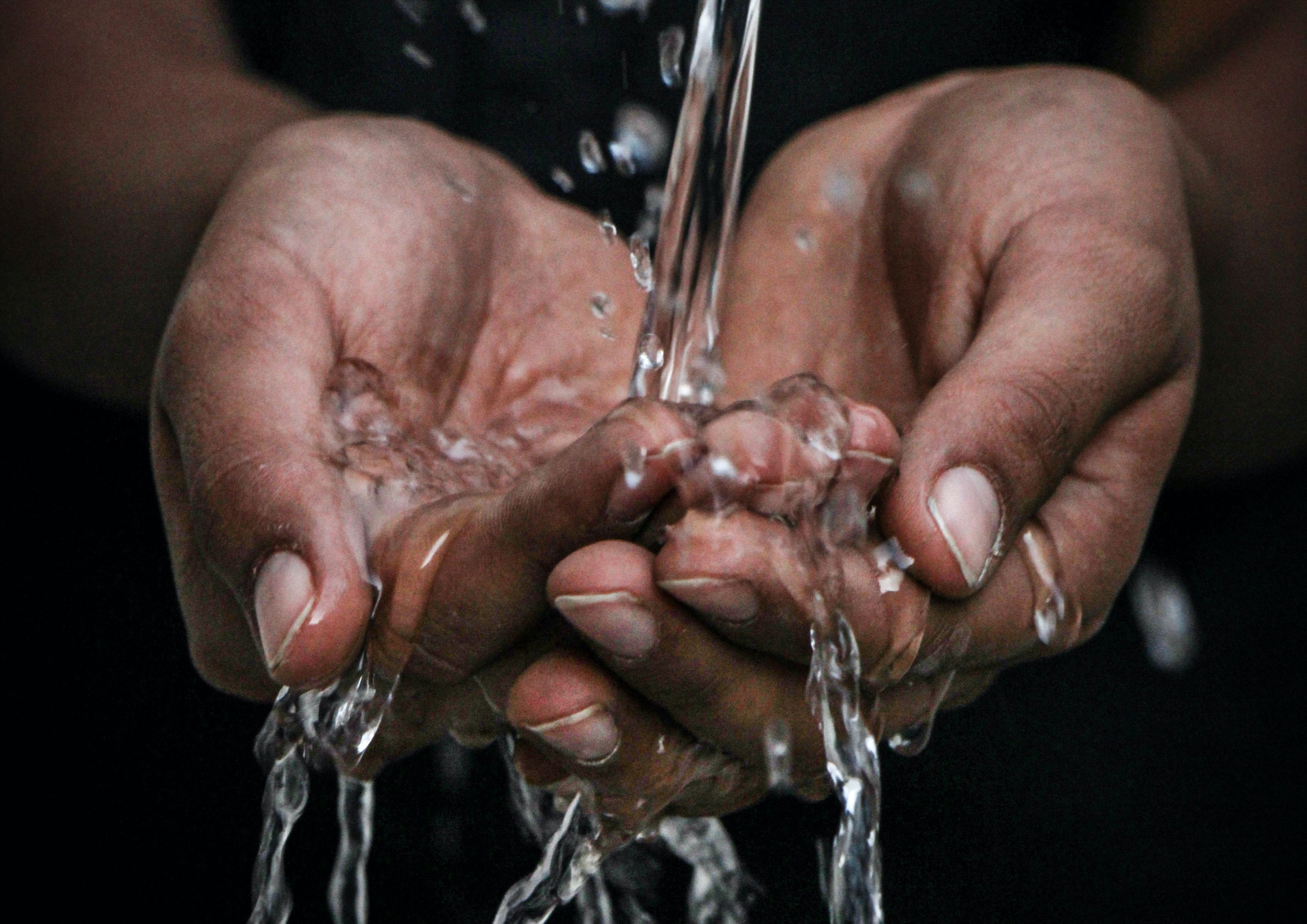 collecting water in cupped hands