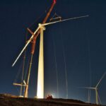 light in the night lighting up wind turbine