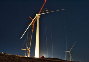 light in the night lighting up wind turbine
