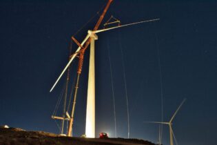 light in the night lighting up wind turbine