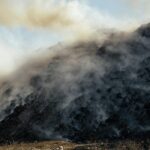 landfill filled with smoking trash