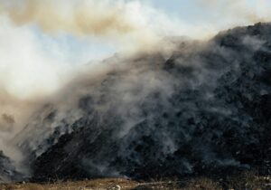 landfill filled with smoking trash