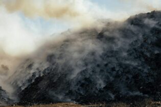 landfill filled with smoking trash