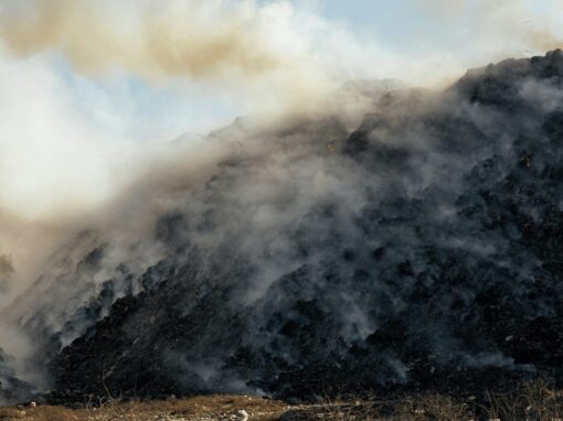 landfill filled with smoking trash