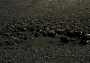 pothole filled with water on a public road