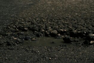 pothole filled with water on a public road