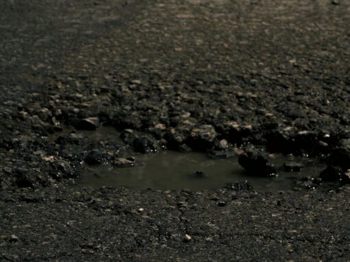 pothole filled with water on a public road