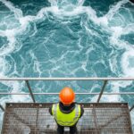 water governance as man stands over water system