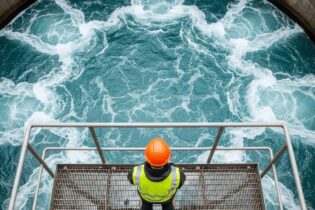 water governance as man stands over water system