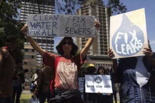Clean water for all sign during march