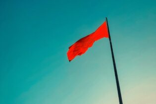 red flag warning against blue background