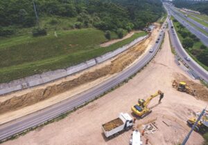 Building construction site with cranes and trucks