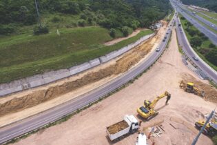 Building construction site with cranes and trucks
