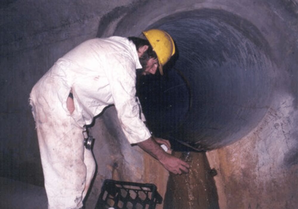 Jarrod Ball sampling water that had been contaminated by landfill leachate seepage