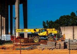 construction site with Grove machine and steel poles