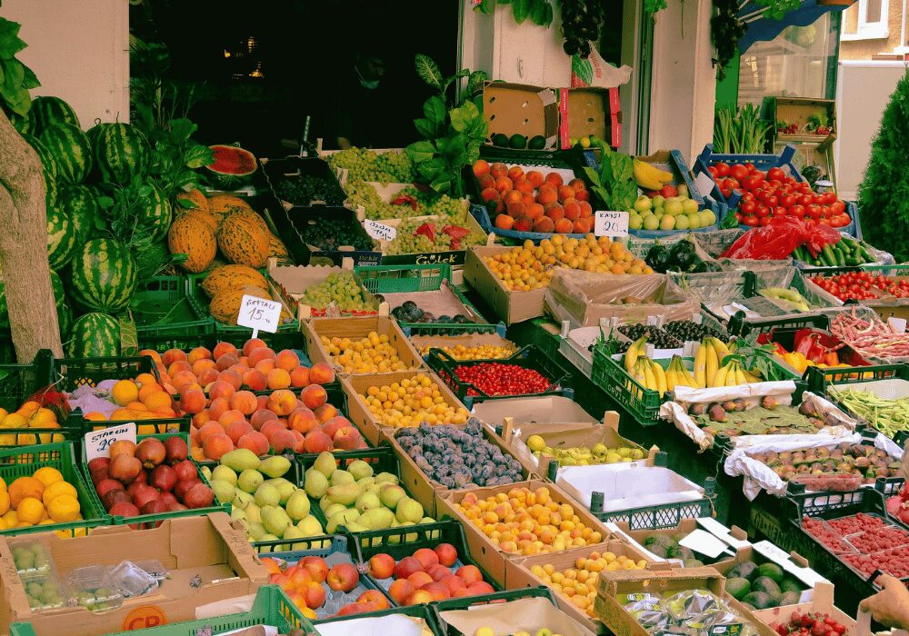 trays of organic fruit and vegetables at a market