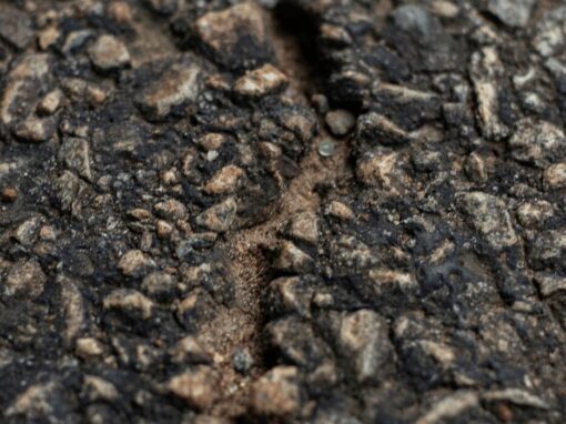 crack in a road exposing cement