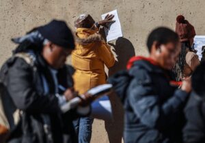 people completing job application forms in the open