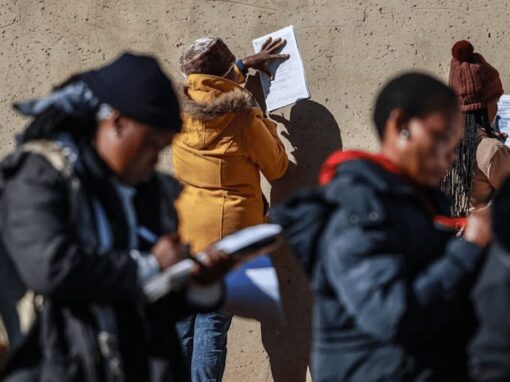 people completing job application forms in the open