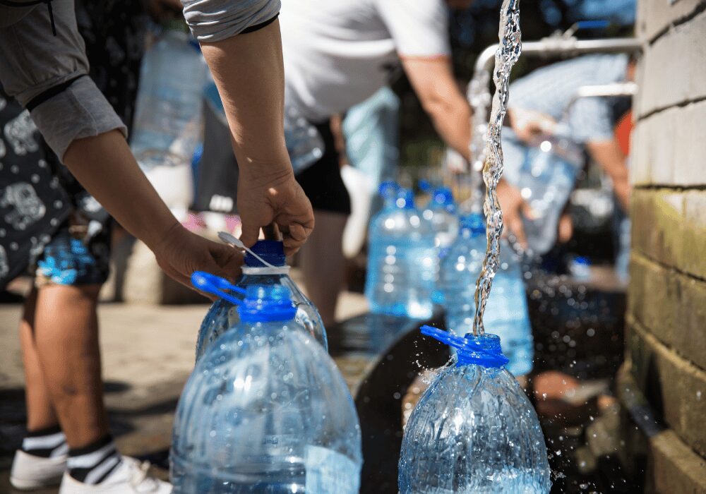 people filling plastic water bottles from Rand Water