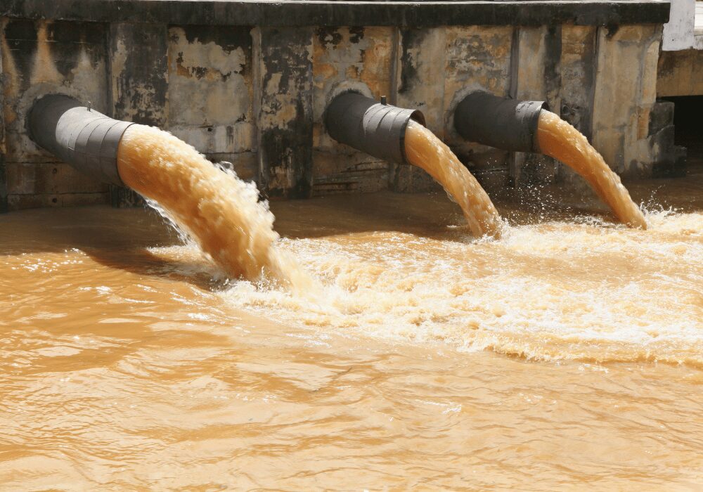 water pouring out three water dam outlets