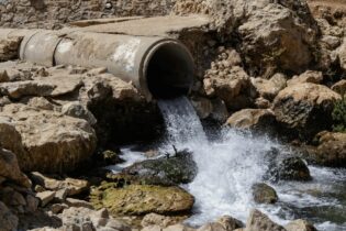 Groundwater coming out of large cement pipe