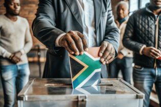 South African flag into voting ballot box