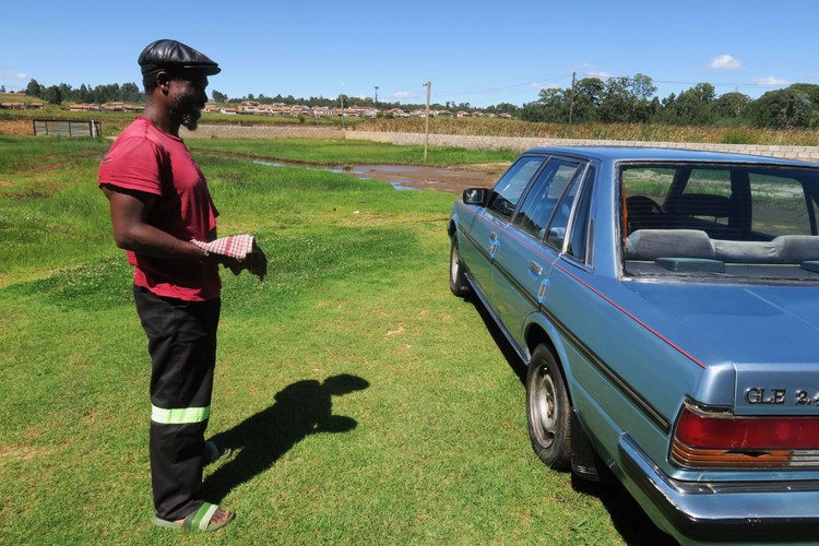 Truck driver Dennis Dladla cleans his classic Toyota Cressida