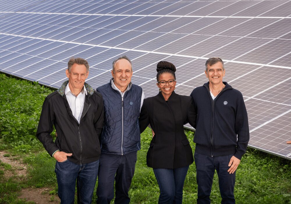 Volkswagen Group Africa team photo infront of solar panel