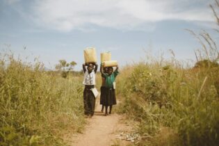 borehole water collection by children in Africa