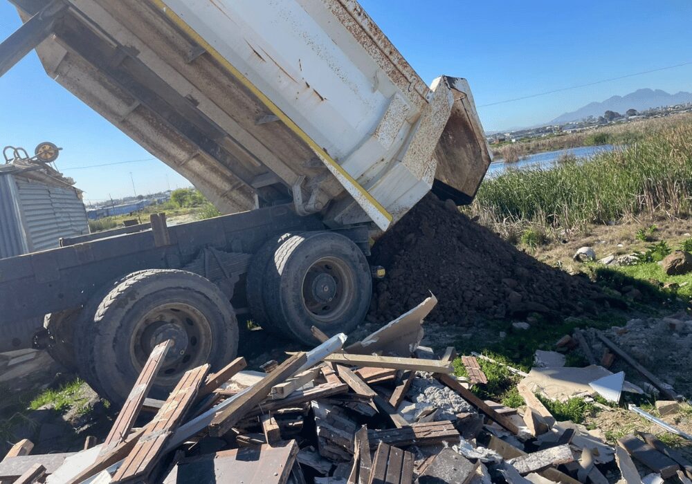 dump truck dropping off soil in illegal area
